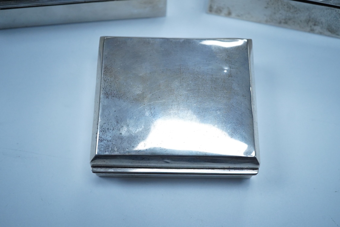 Three assorted George V/George VI silver mounted cigarette boxes, including two with engine tuned covers, the largest by Joseph Gloster Ltd, Birmingham, 1946, 12.8cm.